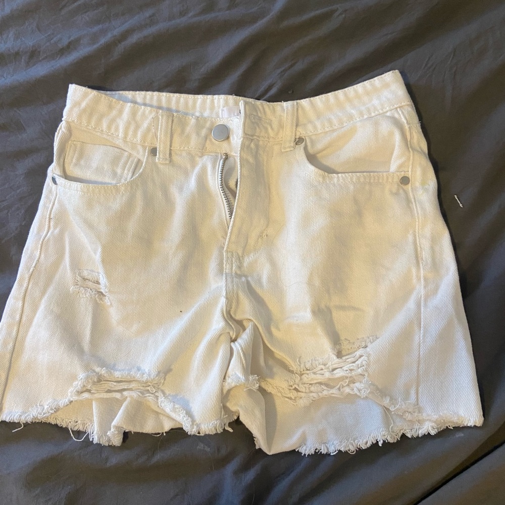 Distressed white jean shorts